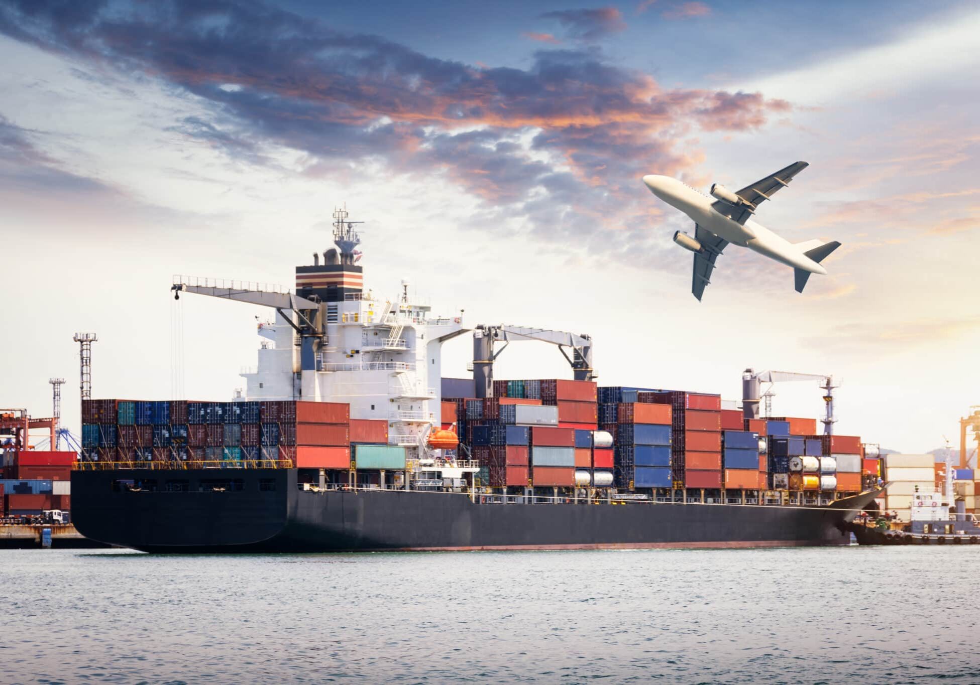 Container Cargo freight ship with working crane bridge in shipyard at dusk for Logistic Import Export background sunrise,sun light. American Lamprecht shipping from switzerland to usa